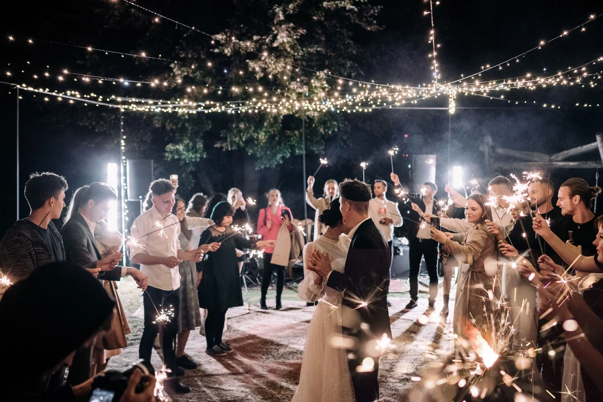 Wedding couple sparkler exit at night